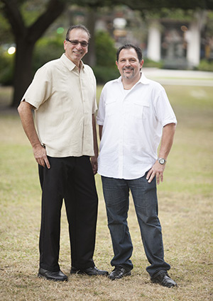 Two owners of Pannullos Italian Restaurant standing in park